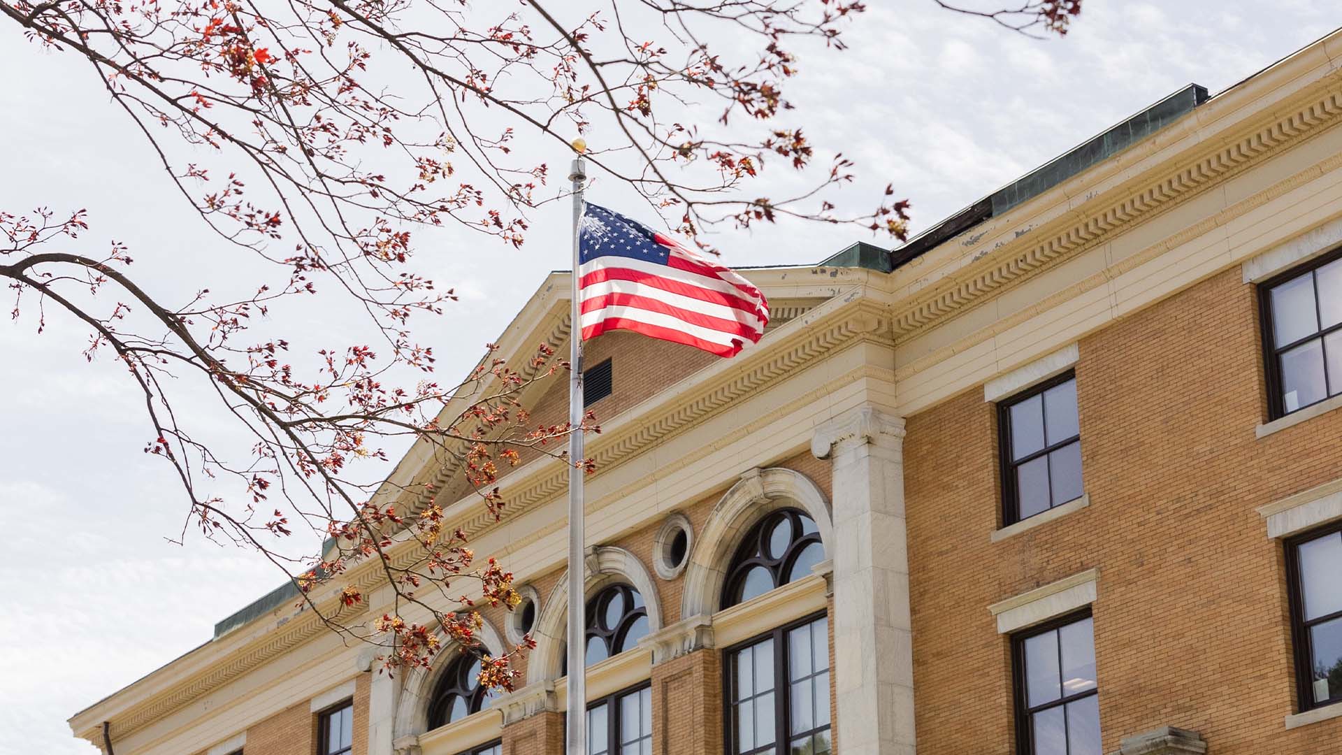MCLA campus Murdock hall with U.S. flag