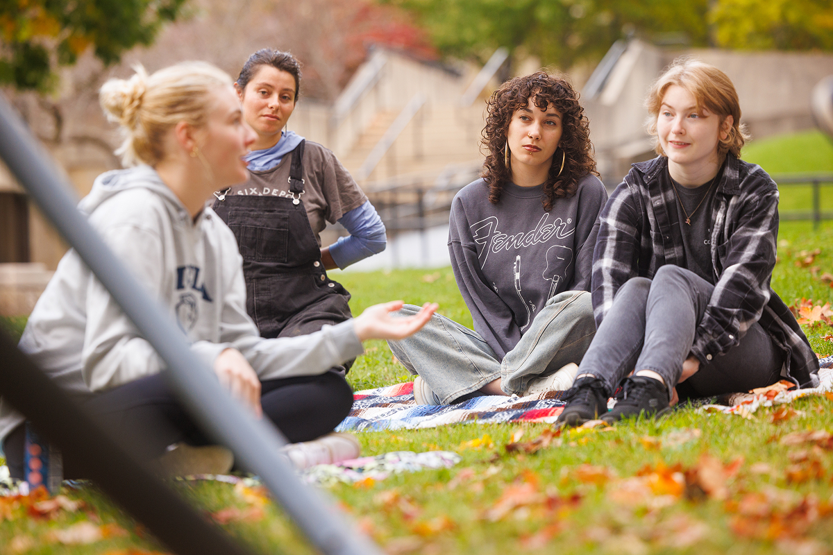 Students conversing on campus in the fall